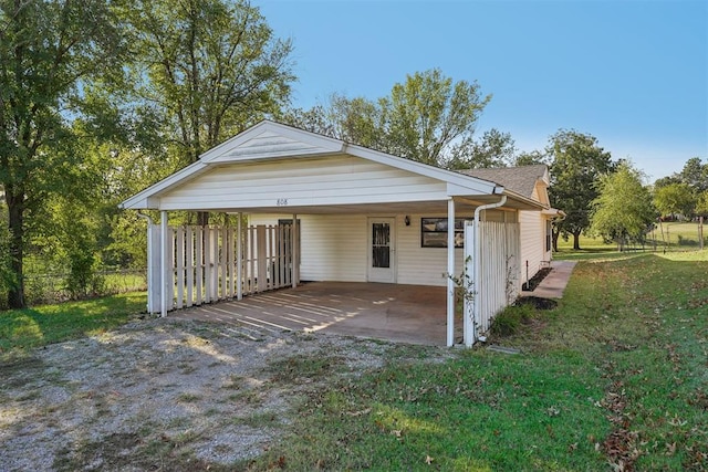 exterior space with a front yard and a carport