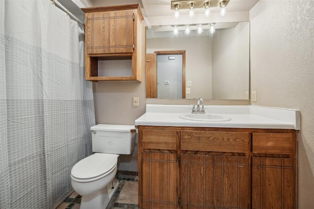 bathroom featuring tile patterned floors, vanity, and toilet