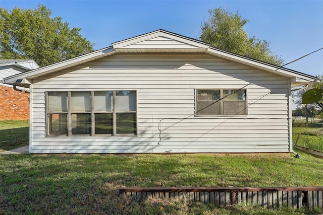 view of side of property with a yard