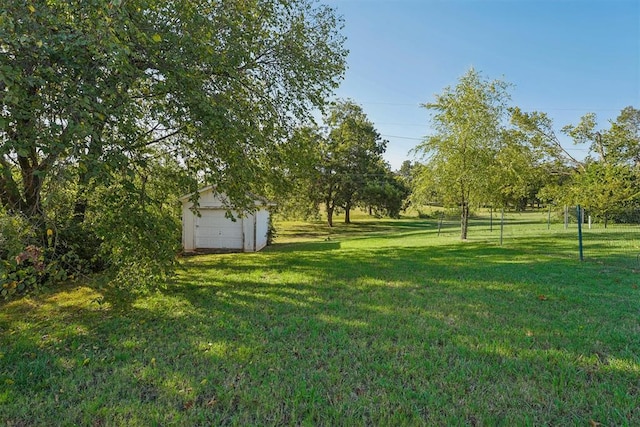 view of yard with a garage and an outdoor structure