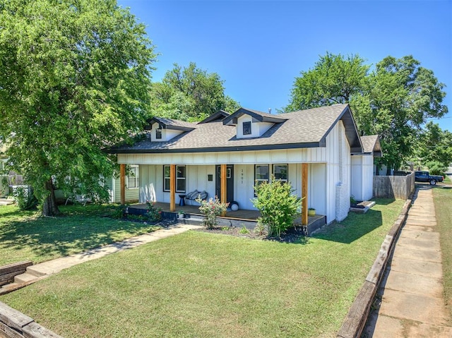 view of front of house with a front yard and a porch