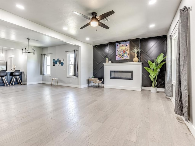 living room with ceiling fan and light hardwood / wood-style floors