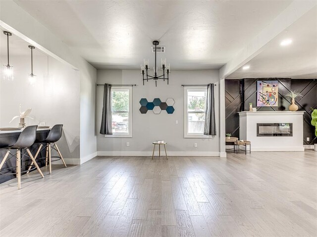 unfurnished dining area with hardwood / wood-style floors and a chandelier