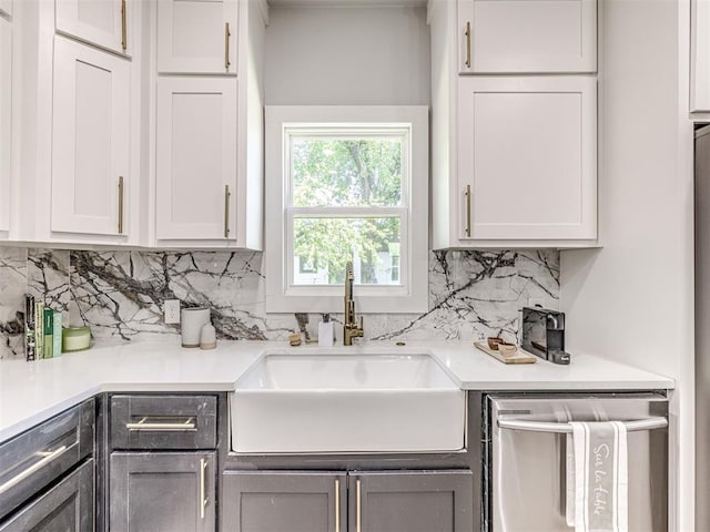 kitchen featuring white cabinets, dishwasher, and sink