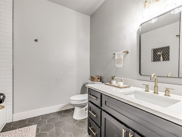 bathroom with tile patterned flooring, vanity, and toilet