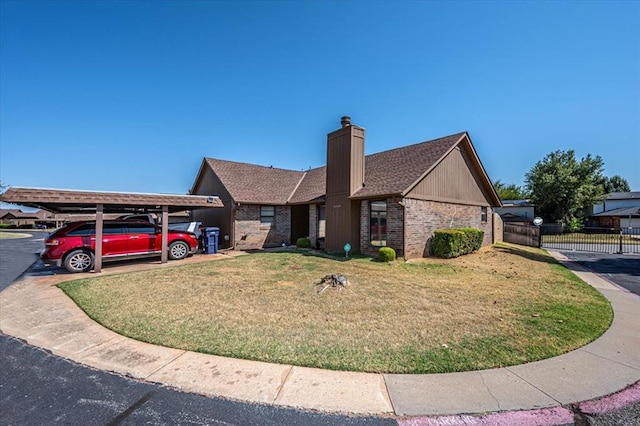 view of front of house featuring a front lawn and a carport