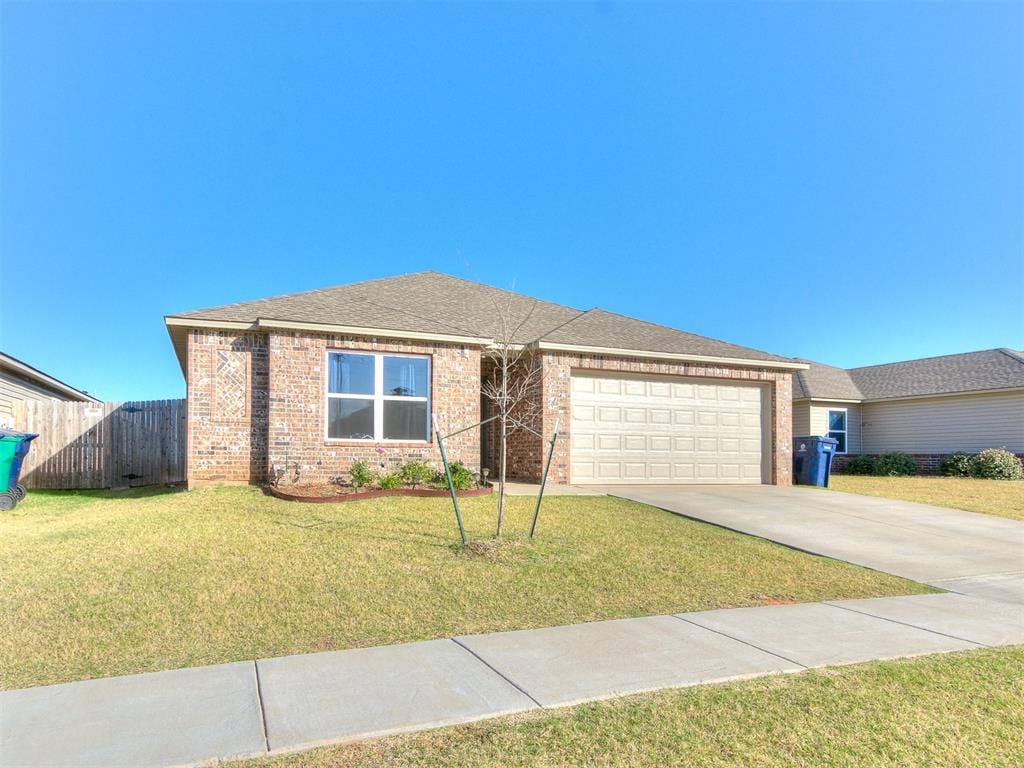 view of front facade with a front yard and a garage