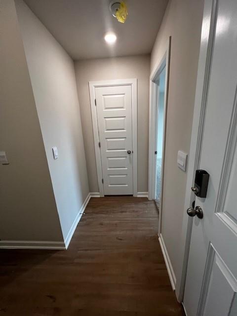 hallway featuring dark hardwood / wood-style flooring