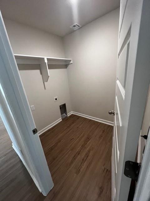 laundry area with dark wood-type flooring and hookup for an electric dryer