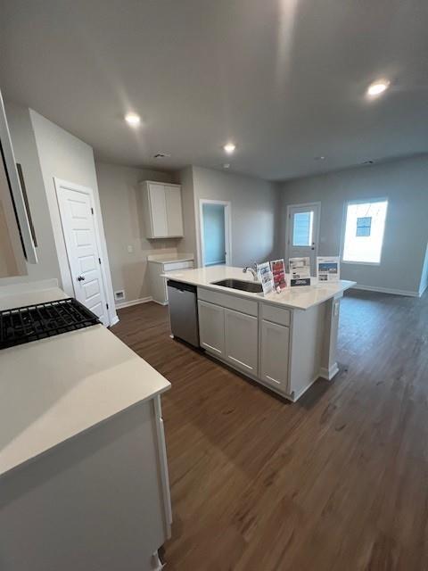 kitchen featuring sink, white cabinetry, a center island with sink, dark hardwood / wood-style flooring, and dishwasher