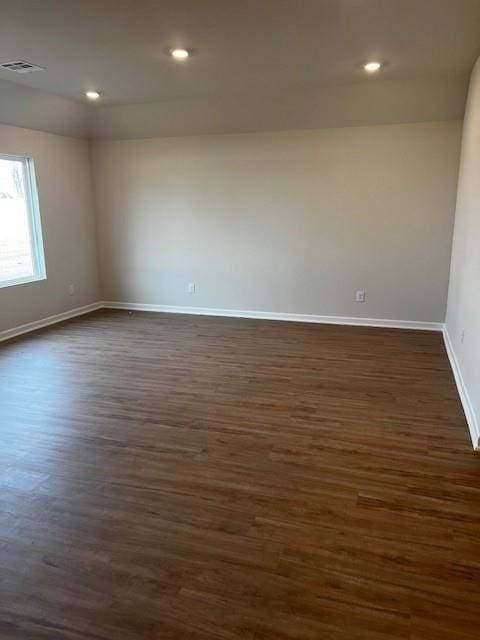 unfurnished room featuring dark hardwood / wood-style flooring