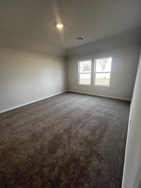 empty room featuring dark colored carpet