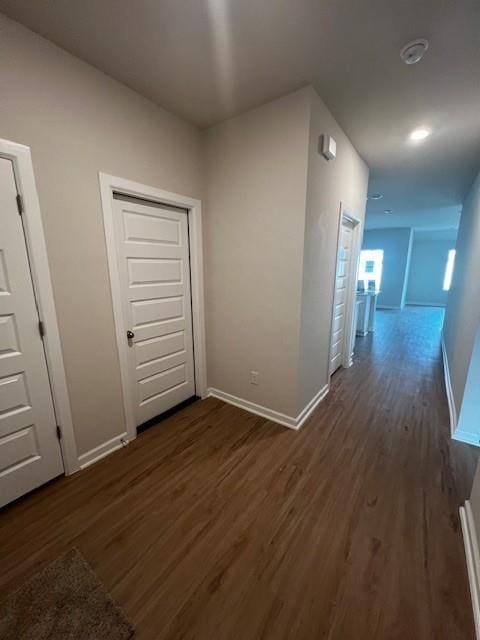 corridor with dark wood-type flooring