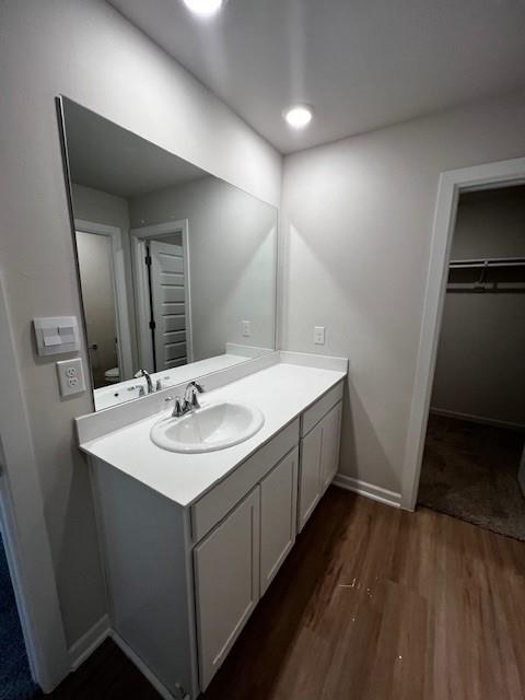 bathroom with vanity and hardwood / wood-style floors