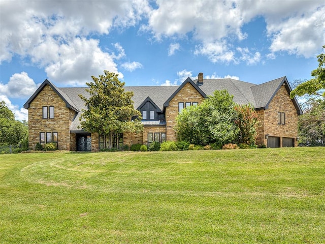 tudor home featuring a front lawn