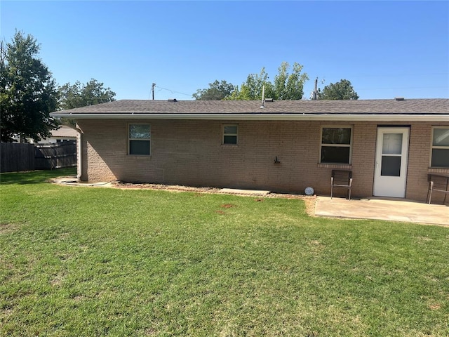 back of house featuring a yard and a patio