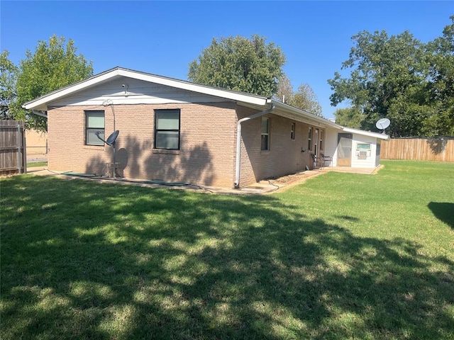 rear view of house featuring a lawn