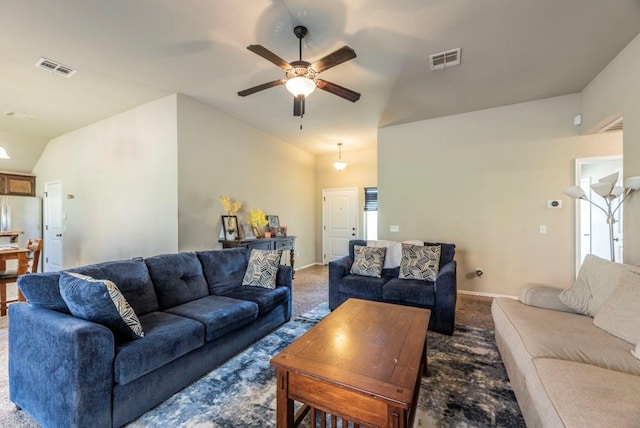 carpeted living room featuring ceiling fan and vaulted ceiling