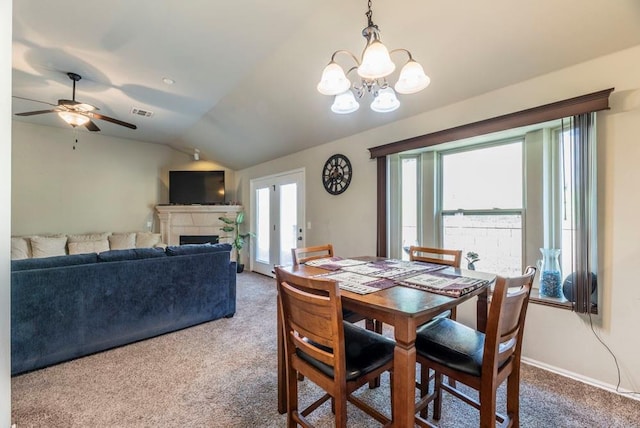 dining room featuring carpet floors, ceiling fan with notable chandelier, and lofted ceiling