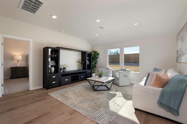 living area with vaulted ceiling, wood finished floors, visible vents, and recessed lighting