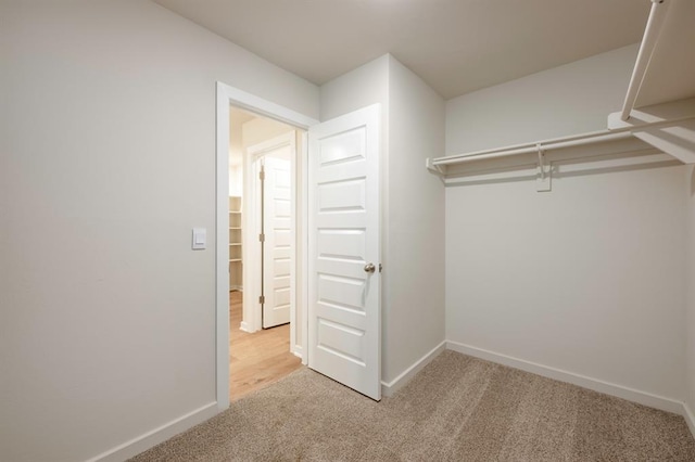 walk in closet with carpet