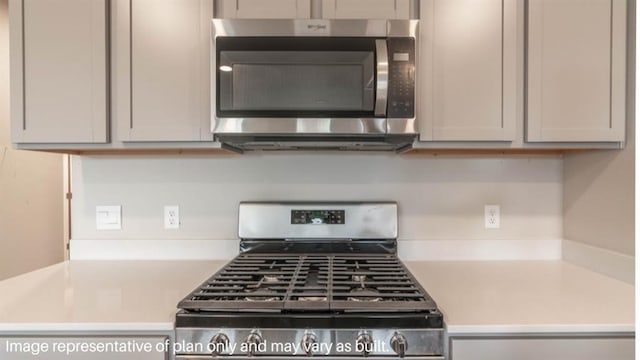 kitchen featuring appliances with stainless steel finishes, gray cabinets, and light countertops