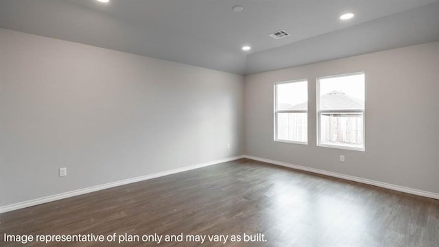 empty room with dark wood-style floors, baseboards, visible vents, and recessed lighting