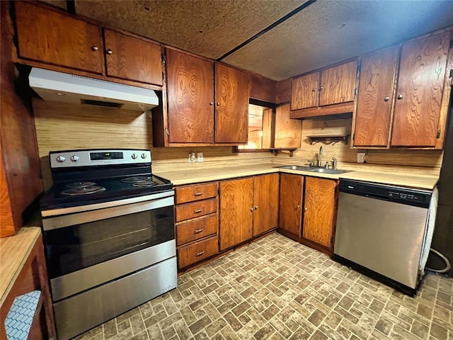 kitchen with stainless steel appliances, wood walls, and sink