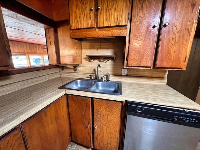 kitchen with wooden walls, dishwasher, and sink