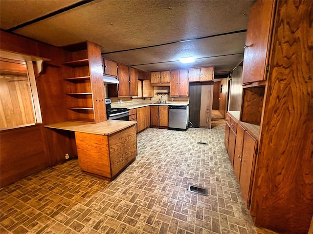 kitchen with dishwasher, black range with electric stovetop, sink, wooden walls, and a textured ceiling