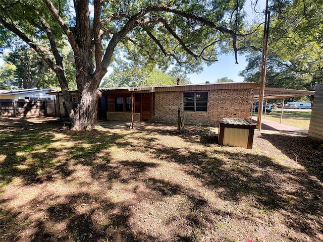 back of property featuring a carport