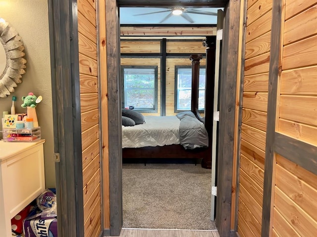 bedroom featuring hardwood / wood-style floors and wood walls