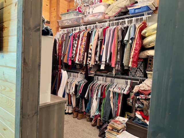 walk in closet with carpet flooring