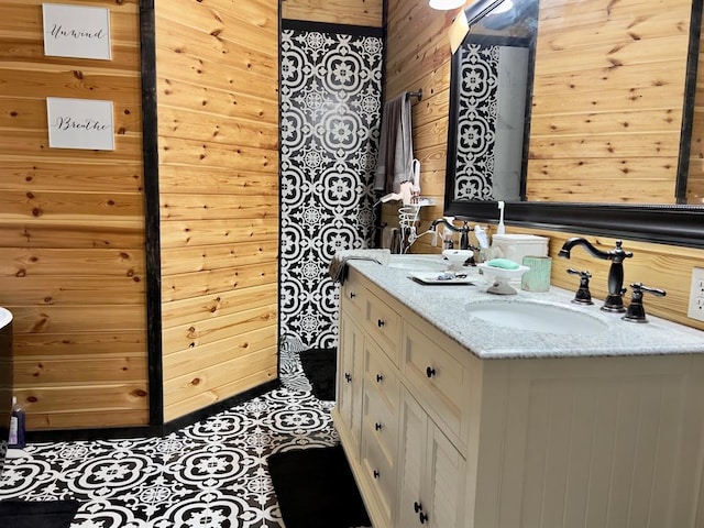 bathroom with wood walls and vanity