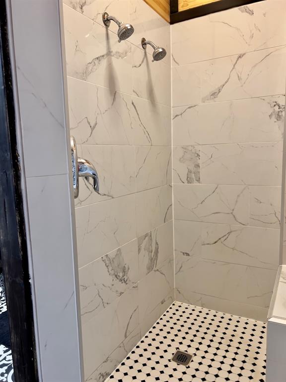 bathroom with a tile shower