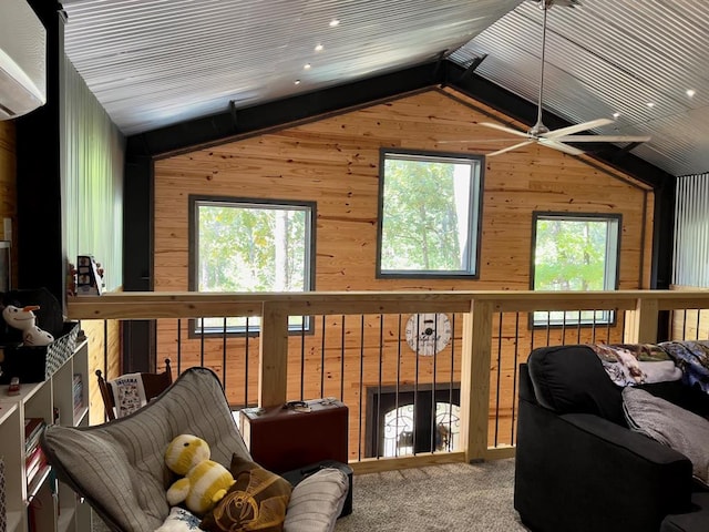 interior space with ceiling fan, an AC wall unit, wood walls, carpet floors, and lofted ceiling