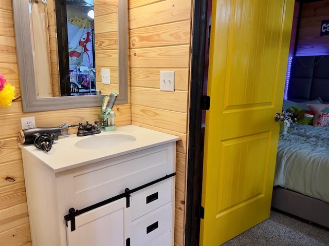 bathroom with vanity and wooden walls