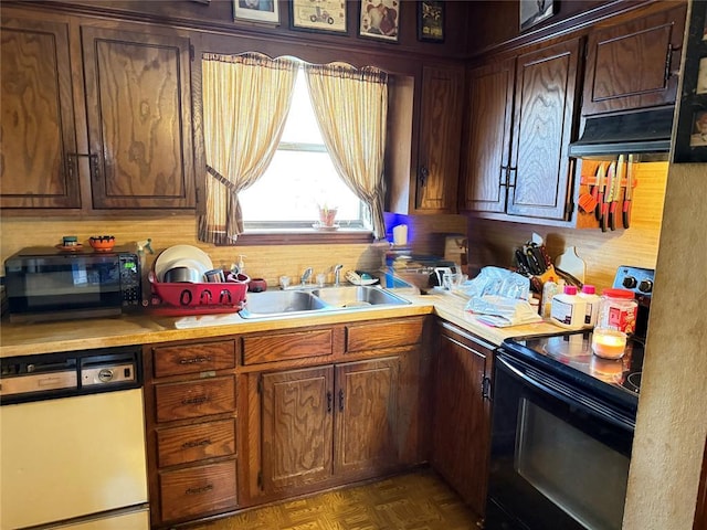 kitchen with dark parquet flooring, sink, dark brown cabinetry, and black appliances