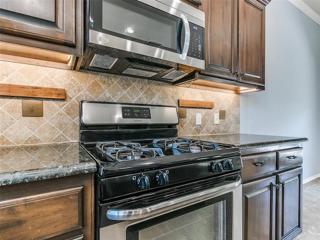 kitchen with appliances with stainless steel finishes, dark brown cabinetry, tasteful backsplash, and dark stone counters