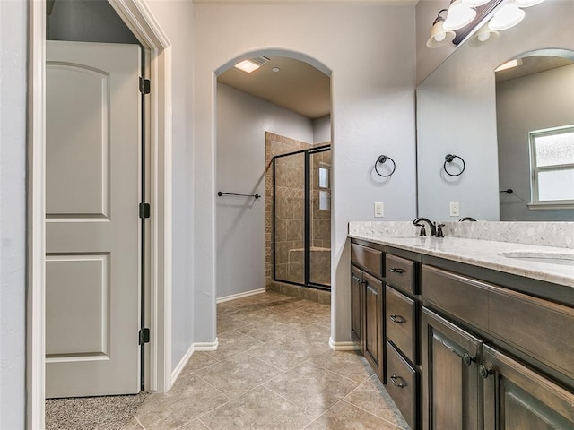 bathroom featuring vanity and a shower with door