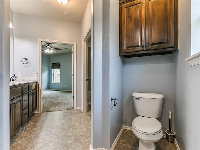 bathroom featuring toilet, ceiling fan, and vanity