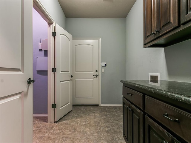 clothes washing area featuring washer hookup and cabinets