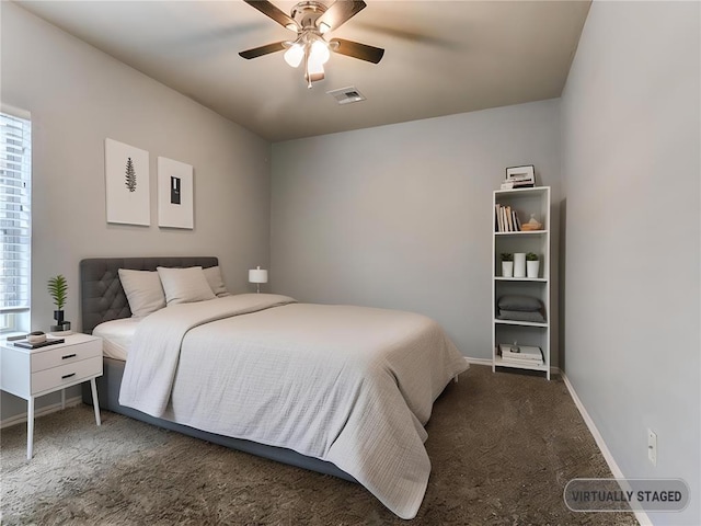 carpeted bedroom featuring ceiling fan and multiple windows