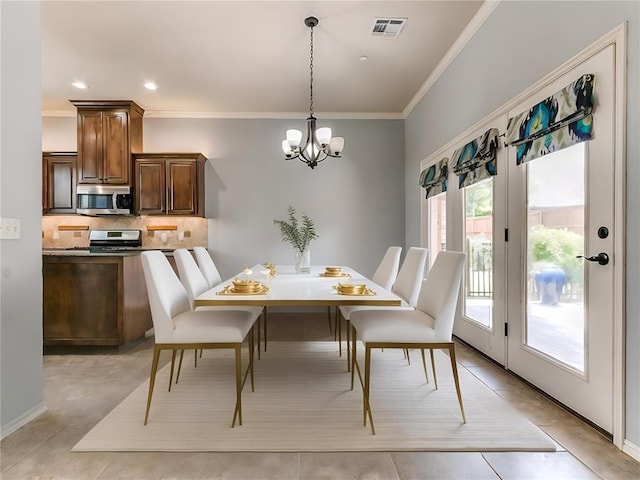 dining space with light tile patterned flooring, an inviting chandelier, and ornamental molding