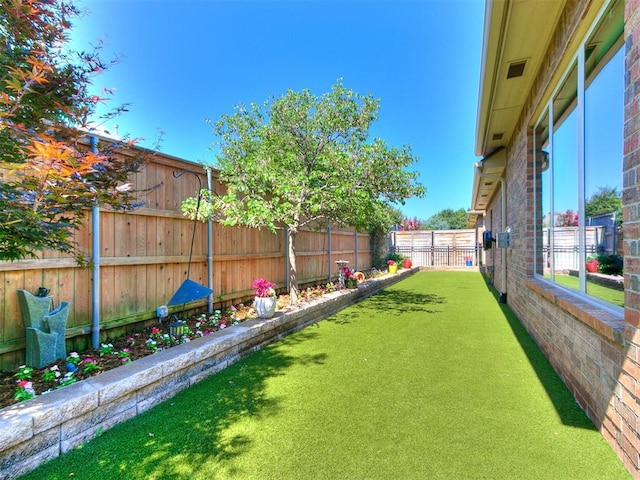 view of yard with a fenced backyard