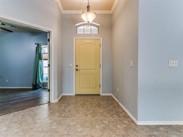 entrance foyer with visible vents, baseboards, and crown molding