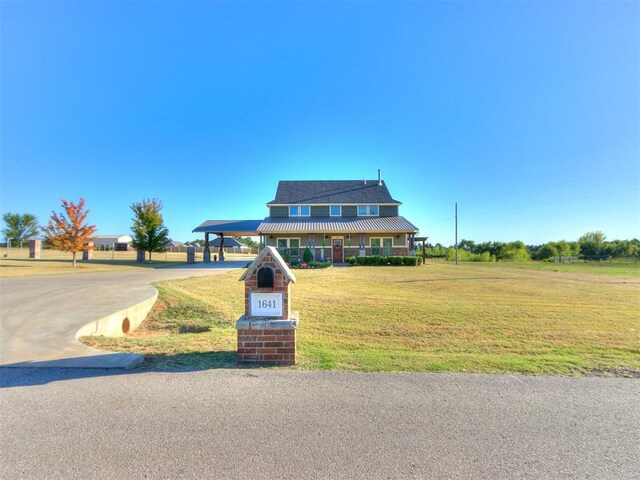 view of front facade with a front lawn and a carport