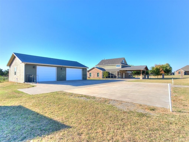 view of front of house with an outbuilding, a front lawn, a carport, and a garage