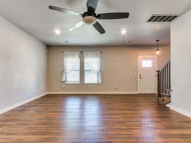 unfurnished living room featuring dark hardwood / wood-style floors and ceiling fan