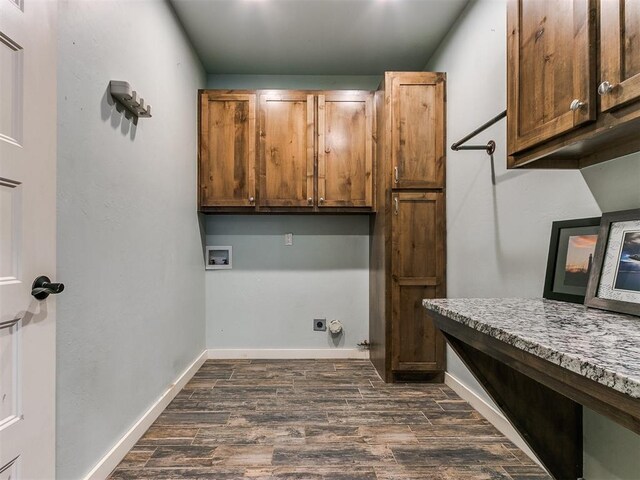 washroom featuring hookup for a washing machine, cabinets, dark hardwood / wood-style floors, and hookup for an electric dryer